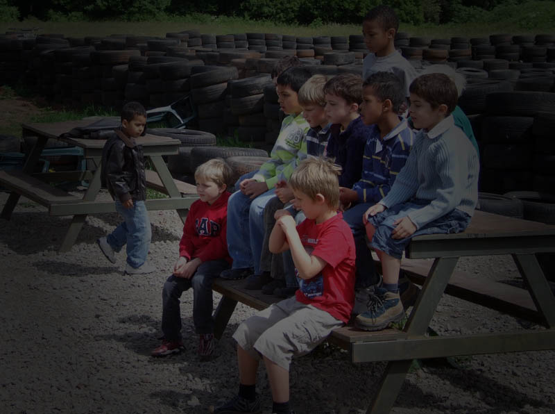 A photo of a group of children being given a quad biking safety briefing before riding